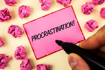 Text sign showing Procrastination Motivational Call. Conceptual photo Delay or Postpone something boring written by Man Sticky Note paper holding Marker plain background Paper Balls.
