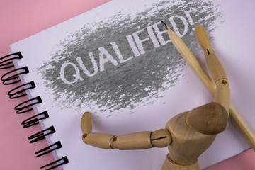 Conceptual hand writing showing Qualified Motivational Call. Business photo showcasing Certified to perform a job Competent Experienced written Notepad plain background wooden Jointed Toy Pencil