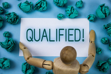 Conceptual hand writing showing Qualified Motivational Call. Business photo text Certified to perform a job Competent Experienced written Sticky note paper Blue background Paper Ball Jointed Toy
