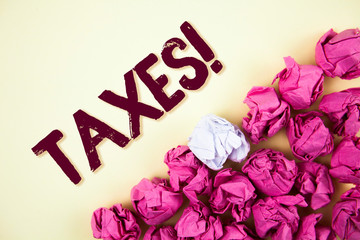 Text sign showing Taxes Motivational Call. Conceptual photo Money demanded by a government for its support written Plain background Crumpled Paper Balls next to it.