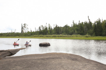 Whiteshell Provincial Park, Manitoba / Canada - August 10, 2019: Son and Dad Canoeing at Rainbow Falls.