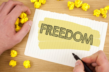 Naklejka premium Writing note showing Freedom. Business photo showcasing Going out for a vacation, students having liberty to go world tour written Tear Notebook Paper wooden background Marker Paper Balls.