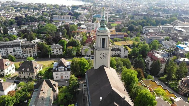 Beautiful drone aerial of Z&uuml;rich, the biggest city in Switzerland. Moving shot around a church, located in district 6 in Fluntern. There are moving cars and public transport in the shot.