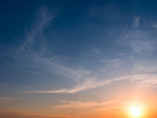 Sunset and colored cirrus clouds on a bright blue sky.