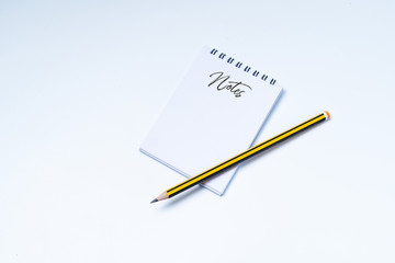 Note text on notepad and pencil isolated on white background. copy space