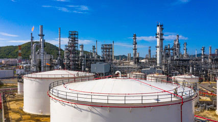 Oil​ refinery​ and​ petrochemical​ plant industrial working with fire and blue sky...