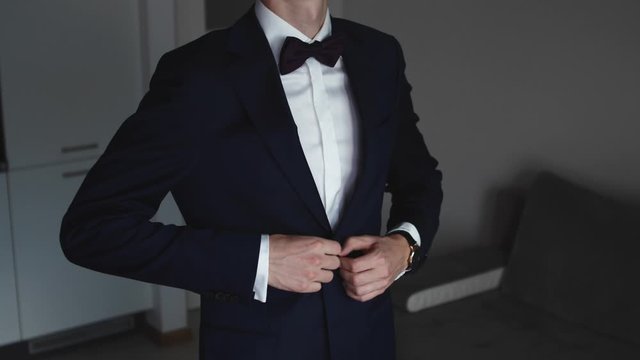 Stylish Man In A Suit Buttoning Jacket. Close Up