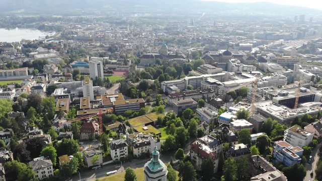 Beautiful drone aerial of Z&uuml;rich, the biggest city in Switzerland. Tilting upwards from church exposing city and view of the university.