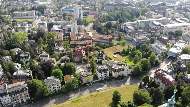 Beautiful drone aerial of Z&uuml;rich, the biggest city in Switzerland. Shot tilting upwards from street with moving cars.