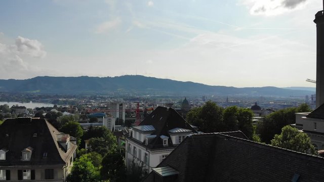 Beautiful drone aerial of Z&uuml;rich, the biggest city in Switzerland. Shot moving upwards from houses, later exposing the city.