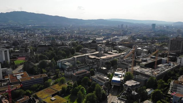 Beautiful drone aerial of Z&uuml;rich, the biggest city in Switzerland. The shot is moving backwards from the university hospital (USZ) and the university (ETH).
