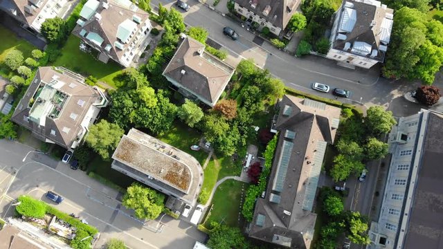 Beautiful drone aerial of Z&uuml;rich, the biggest city in Switzerland. Shot starts with top view of houses. Later tilting upwards, exposing city and the lake of Z&uuml;rich.