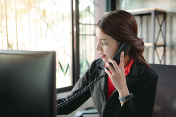 Businesswoman making a phone call.Talking on Landline phone.Concept for communication, contact us and customer service support.