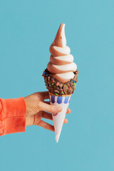 ice cream in a child's hand. soft serve ice cream cone