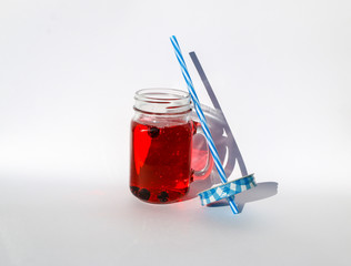 summer berry lemonade in glass jar-mug with lid and  straw on  white background.