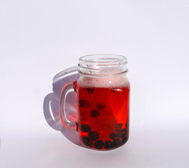 summer berry lemonade in glass jar-mug with lid and  straw on  white background.