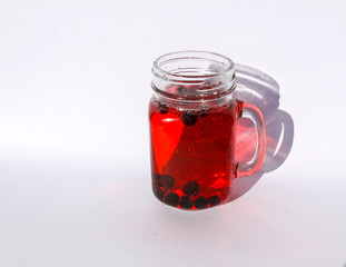 summer berry lemonade in glass jar-mug with lid and  straw on  white background.