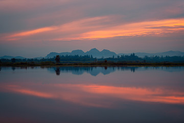 Beautiful sunrise with red sky and reflection in the lake...