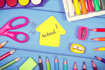 School accessories and shape of building on blue boards. Back to school concept