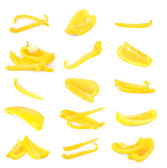 Set of cut ripe yellow bell peppers on white background
