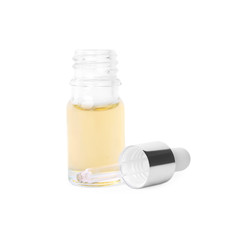 Glass bottle of essential oil and pipette on white background