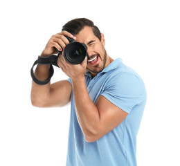 Young professional photographer taking picture on white background