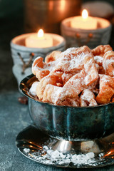 Fat Thursday celebration - traditional Angel Wings cookies decorated with powdered sugar.