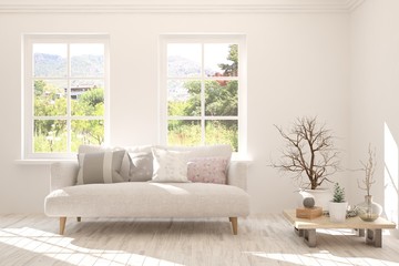 Stylish room in white color with sofa and summer landscape in window. Scandinavian interior design. 3D illustration