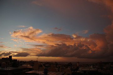 Fototapeta na wymiar 海沿いの都会と夕暮れの積乱雲