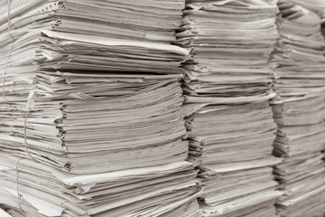 stack of documents on desktop in office.