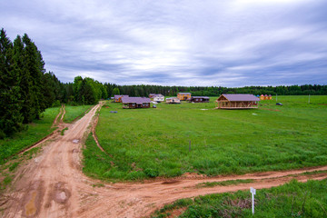 Obraz premium construction of a new village on a field near the forest