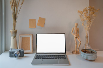 Stylish professional photographer workplace with blank screen laptop computer.