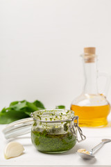 Fresh pesto with basil on wooden bsckground