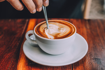 Coffee milk latte on wood table at coffee shop for drink in coffee time