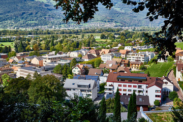 Mountains and a view from the height of the valley with houses at the bottom of a Sunny summer day