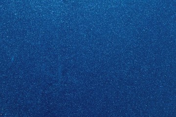 Blue glitters. Abstract shiny background. Design paper texture for decoration and design of Christmas, New Year or other holiday pictures. Beautiful packaging material.