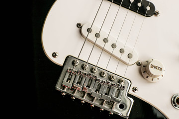 Electronic black and white bass guitar close up. Guitar as a symbol of yin yang.