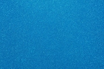Light blue glitter. Abstract shiny background. Design paper texture for decoration and design of Christmas, New Year or other holiday pictures. Beautiful packaging material.