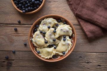 Preparing dumplings with blueberry. making pierogi or pyrohy, varenyky, vareniki. Traditional Russian cuisine, The traditional Ukrainian hand-made vareniki (dumpling) with blueberry inside