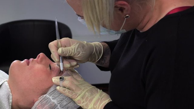 Young girl doing microblading procedure