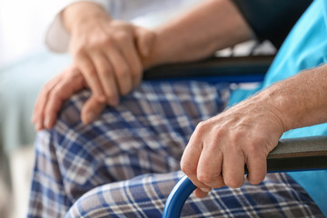 Doctor with elderly man in nursing home, closeup