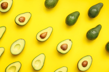 Fresh avocados on color background
