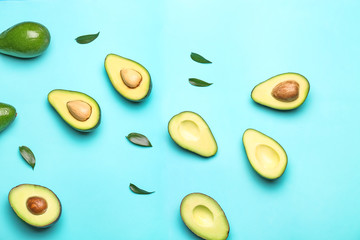 Fresh avocados on color background