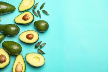 Fresh avocados on color background
