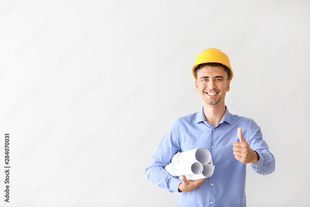 Wall mural handsome male architect showing thumb-up on white background