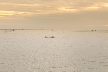Soft ocean waves and bubbles on the beach with a sunset sky background