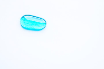 Transparent glass pebble on white background