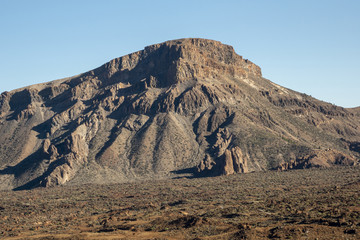 Lonely mountain peak with clear sky on background