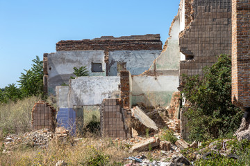 Ruined house. Remains of old houses. Apocalypse. Abandoned city. City of ghosts. Ruins of old historic houses destroyed by an earthquake and devastating operation of urban structures. Broken building