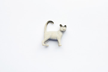 Figurine of a cat on white background